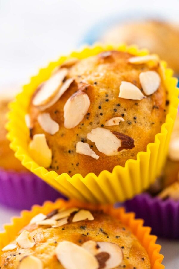 Lemon poppy seed muffins garnished with almond slivers - Arina Photography