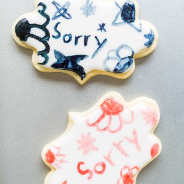 Little Girl Spells 'Sorry' on Iced Sugar Cookies - Arina Photography