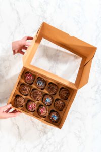 Baking Chocolate Cupcakes with Decadent Chocolate Frosting - Arina Photography Cardboard cupcake gift box filled with frosted chocolate cupcakes, decorated and ready to gift.