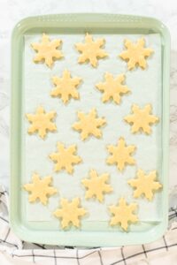 Preparing and Baking Classic Cut-Out Sugar Cookies - Arina Photography A baking tray with unbaked star-shaped sugar cookies placed on a cooling rack, ready to go into the oven.