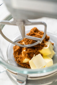 Vibrant Green Gingerbread Cookies for Festive Baking - Arina Photography Butter and brown sugar in a stand mixer, ready to be creamed together for Vibrant Green Gingerbread Cookies for Festive Baking. This step creates a smooth, fluffy texture.