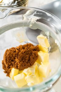 Chocolate Gingerbread Cookie Dough for Holiday Baking - Arina Photography Butter and brown sugar are added to the mixing bowl, key ingredients for Chocolate Gingerbread Cookie Dough. These provide a creamy texture and deep sweetness, which complement the chocolate and spices.