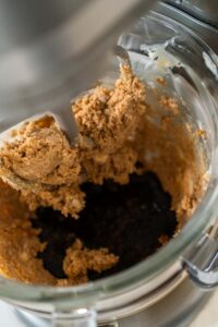Chocolate Gingerbread Cookie Dough for Holiday Baking - Arina Photography Adding the molasses and egg mixture into the creamed butter and sugar in preparation for Chocolate Gingerbread Cookie Dough. This dark, rich molasses will give the dough a deep flavor and color.