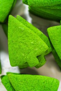 Decorating Festive Christmas Tree Cookies with Royal Icing - Arina Photography Close-up of vibrant green Christmas tree-shaped sugar cookies made from tinted dough, perfect for holiday decorating and gifting – featured in the How to Decorate Christmas Tree Cookies recipe.